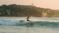 free-photo-of-surfer-riding-waves-at-sunset-in-bali DPRD Denpasar Dorong Sport Tourism sebagai Daya Tarik Baru Bali
